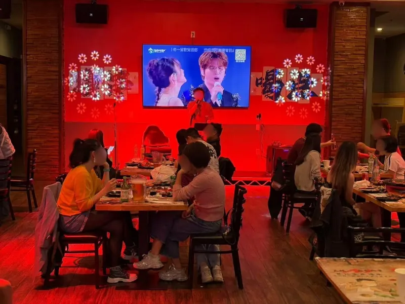 Diners enjoy meals under red ambient lighting at NO WINE NO NIGHT, a Chinese Restaurant in Rowland Heights